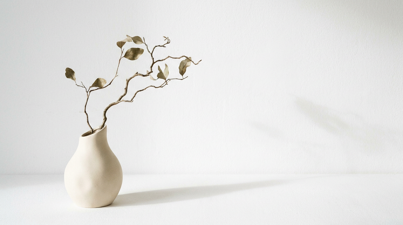 Minimalist still life of a ceramic vase with a thin branch in soft neutral tones made with AI